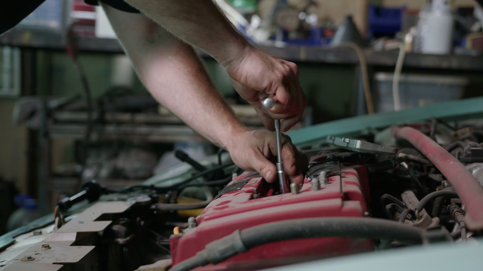 Mechanic's hands tightening engine components