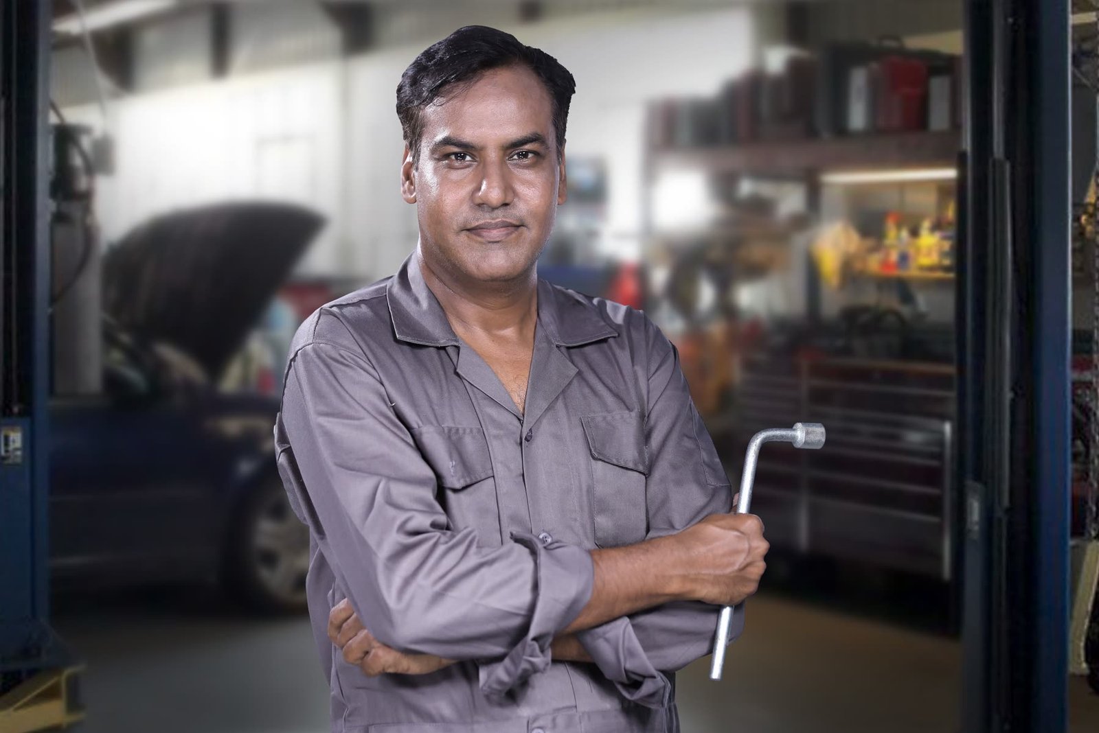 Mechanic in overalls standing in a workshop