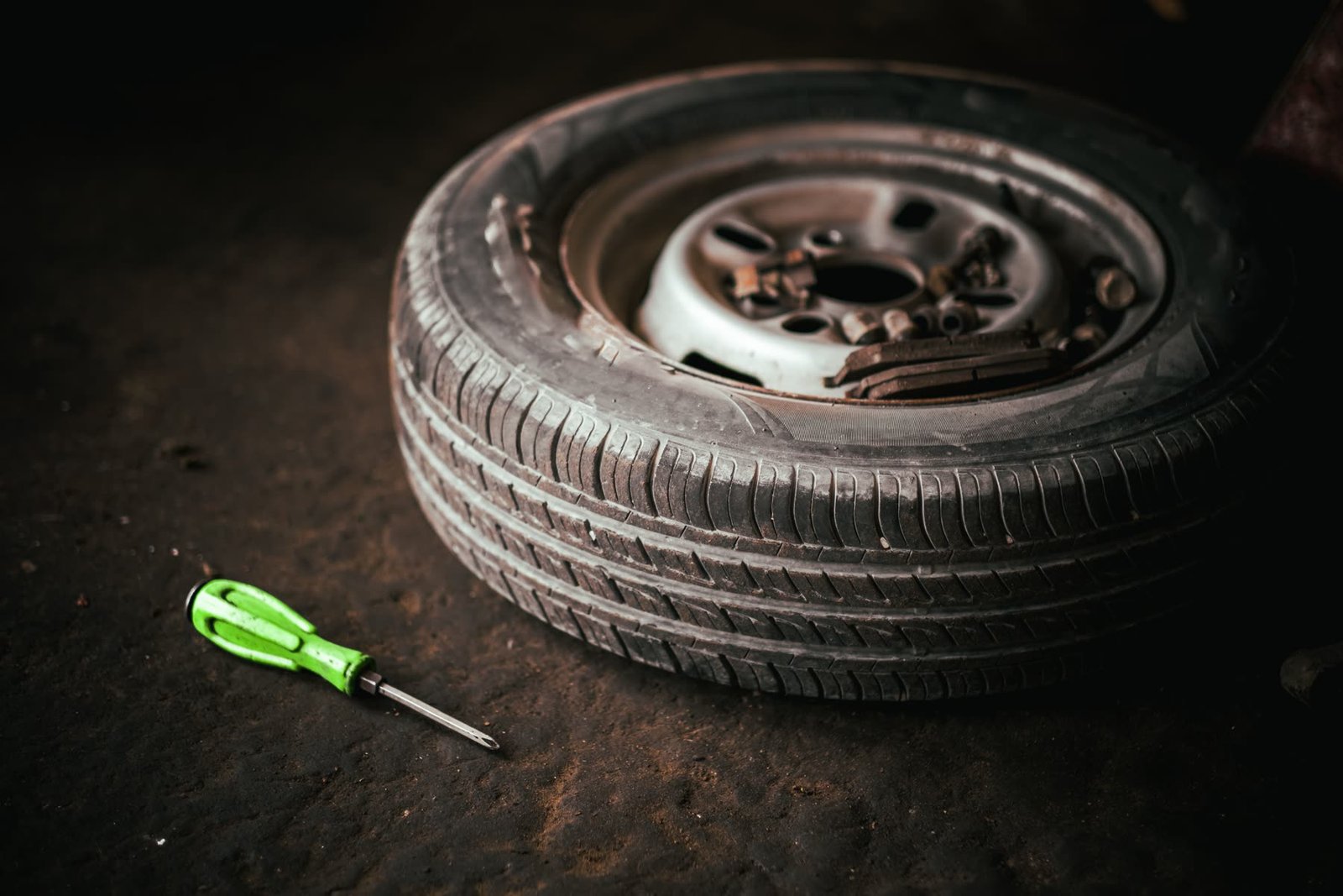 Car wheel and tyre on the workshop floor